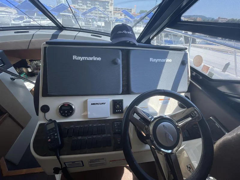 Slide: The Image of Helm of 2016 Sea Ray 470 Sundancer with Raymarine displays and Mercury controls. - 13