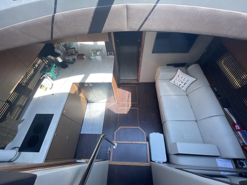 Slide: The Image of Interior of 2016 Sea Ray 470 Sundancer yacht with modern kitchen and cozy seating area. - 14