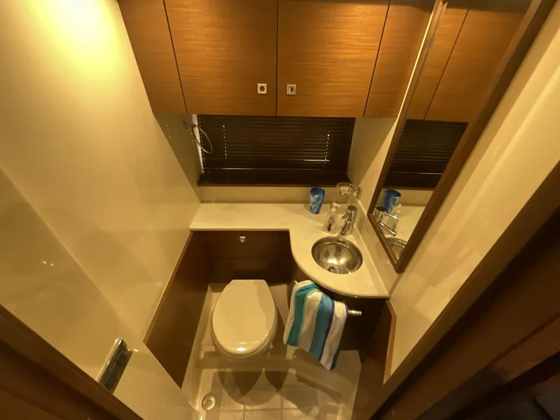 Slide: The Image of Luxurious bathroom in 2016 Sea Ray 470 Sundancer yacht with modern fixtures and wood cabinetry. - 21