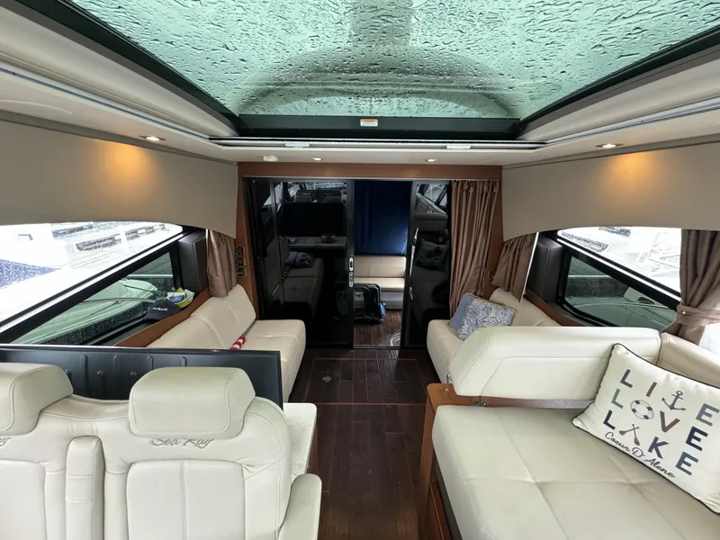 Slide: The Image of Interior of 2016 Sea Ray 470 Sundancer yacht with luxurious seating and panoramic windows. - 24