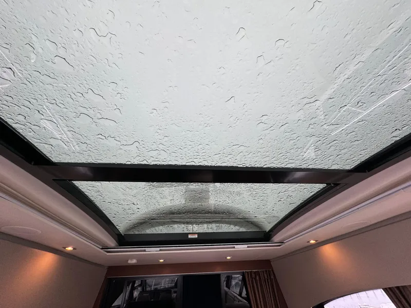 Slide: The Image of Glass roof of 2016 Sea Ray 470 Sundancer with raindrops, interior view. - 25