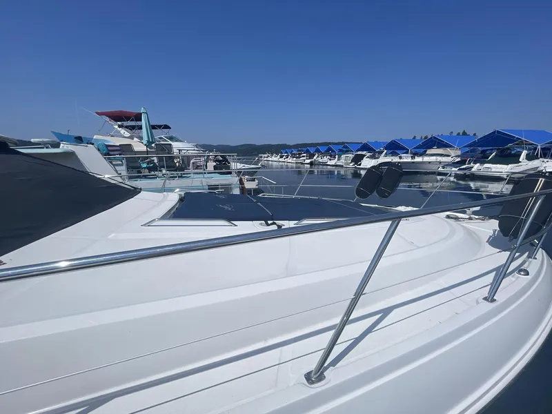 Slide: The Image of 2016 Sea Ray 470 Sundancer yacht docked at marina under clear blue sky. - 3