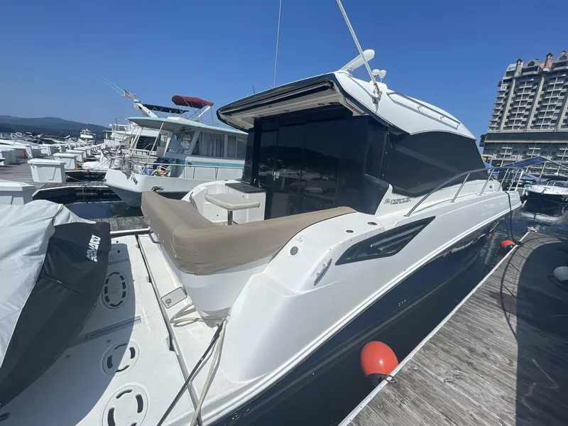 Slide: The Image of 2016 Sea Ray 470 Sundancer yacht docked at marina under clear blue sky. - 4