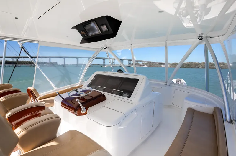 Slide: The Image of 2019 Viking 62 Convertible yacht helm with leather seats and panoramic ocean view. - 25