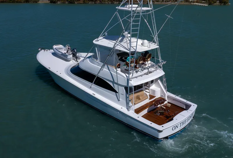 Slide: The Image of 2019 Viking 62 Convertible yacht cruising on calm blue waters. - 44