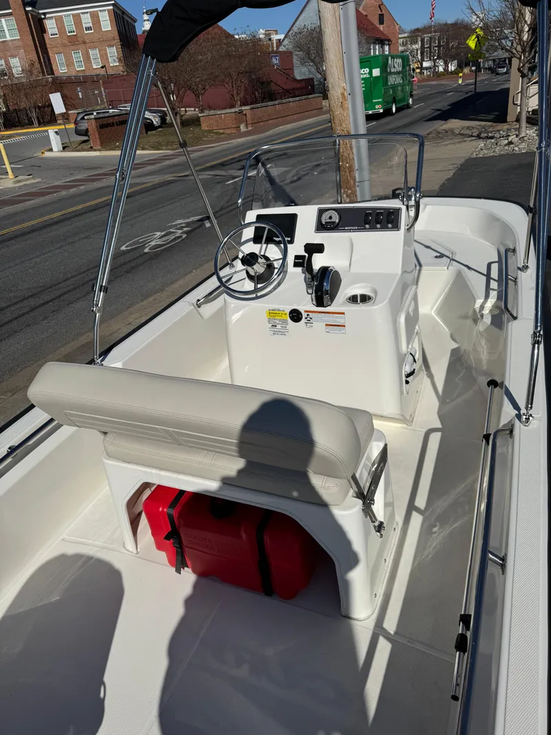 Slide: The Image of 2022 Boston Whaler 150 Montauk boat interior with steering console and seating. - 3