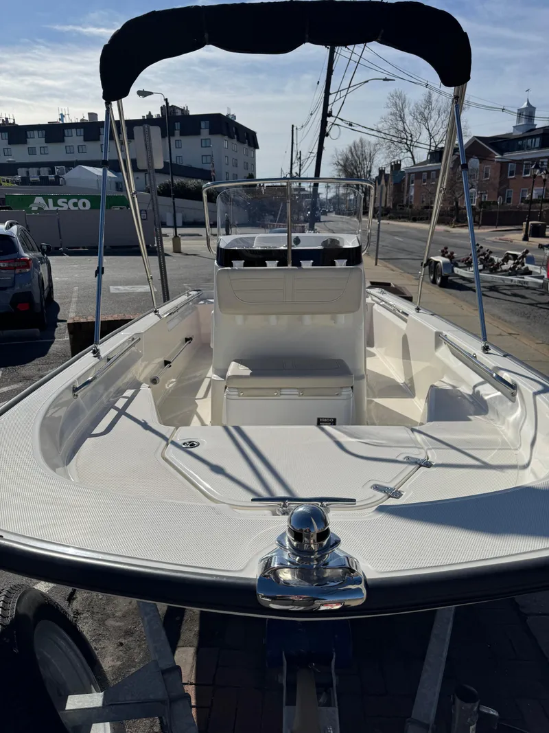 Slide: The Image of 2022 Boston Whaler 150 Montauk boat with canopy, docked in urban setting. - 5