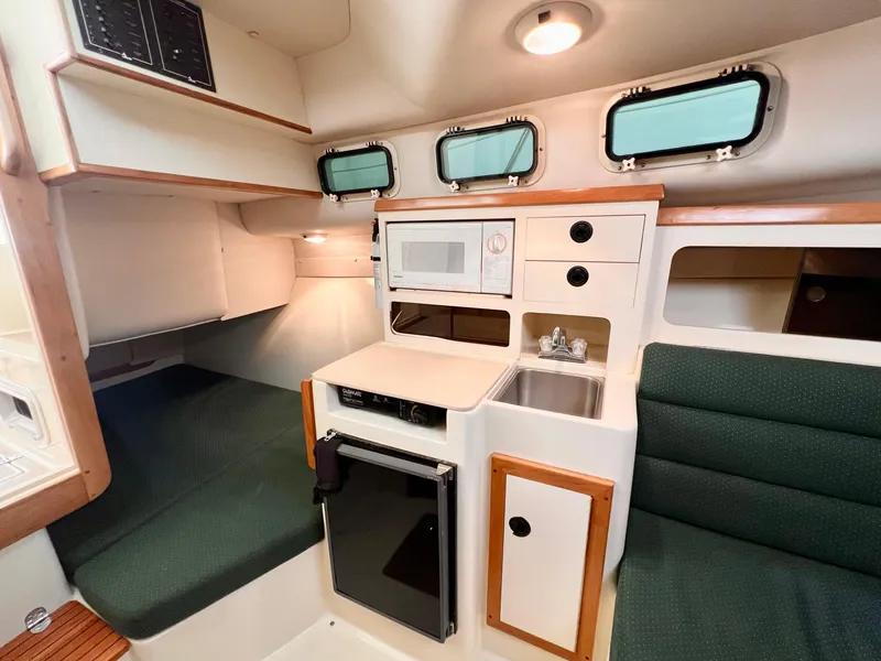 Slide: The Image of Interior of 2000 Albin 28 Tournament Express with kitchenette and seating area. - 13