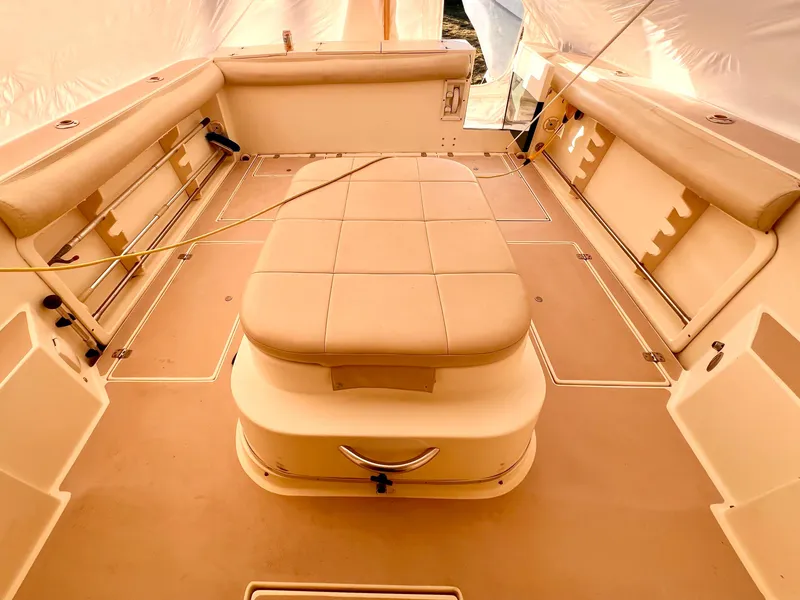 Slide: The Image of 2000 Albin 28 Tournament Express boat interior with beige seating and storage. - 17
