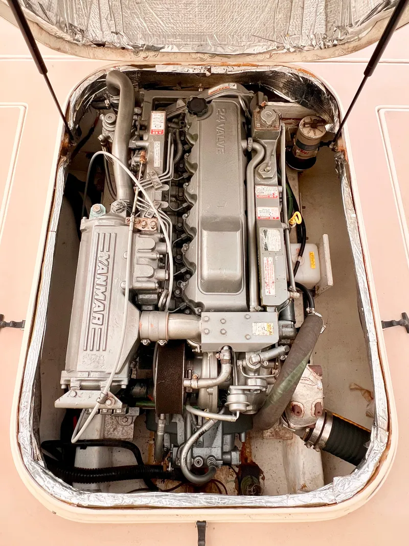 Slide: The Image of Engine compartment of a 2000 Albin 28 Tournament Express boat, featuring a Yanmar engine. - 18