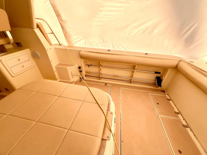 Slide: The Image of Interior of 2000 Albin 28 Tournament Express boat, featuring beige seating and storage compartments. - 20