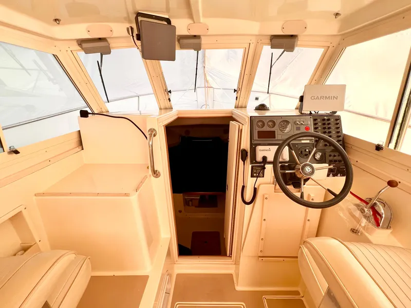 Slide: The Image of Interior of 2000 Albin 28 Tournament Express boat with steering wheel and navigation equipment. - 5