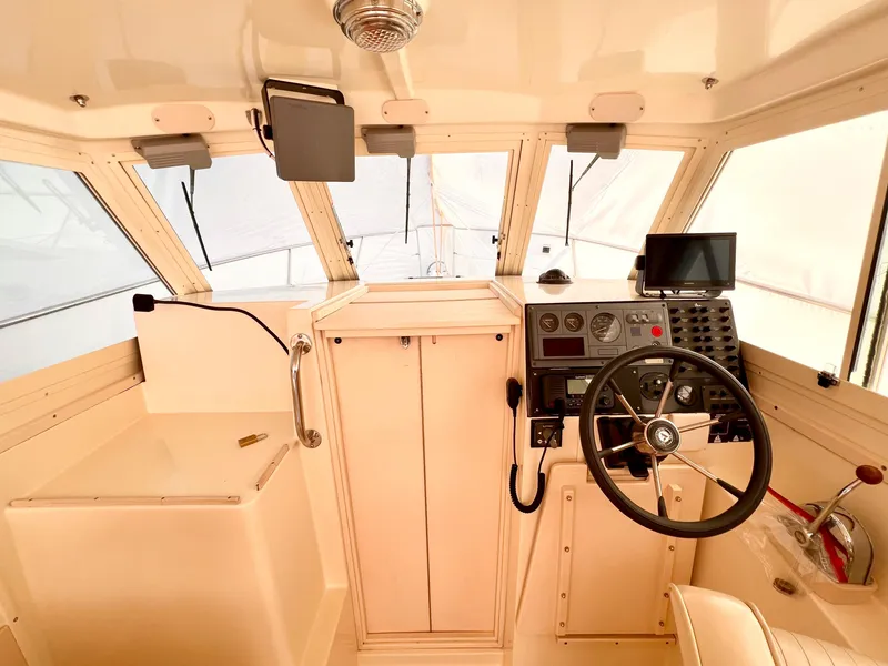 Slide: The Image of 2000 Albin 28 Tournament Express helm with steering wheel and navigation equipment. - 7