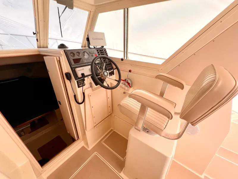 Slide: The Image of Interior helm of 2000 Albin 28 Tournament Express boat with steering wheel and captain's chair. - 8