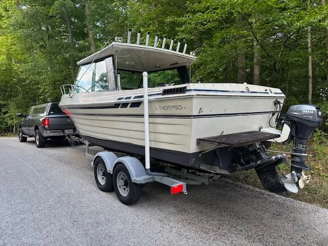 Slide: The Image of 1990 Thompson 240 Fisherman boat on trailer, parked on a forest road. - 10