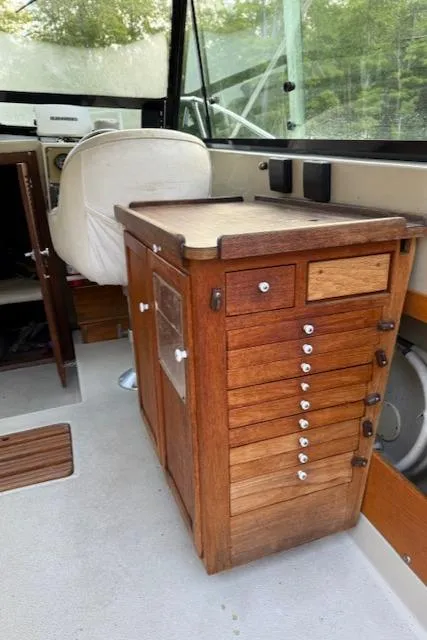 Slide: The Image of Interior of 1990 Thompson 240 Fisherman boat with wooden cabinetry and seating. - 17