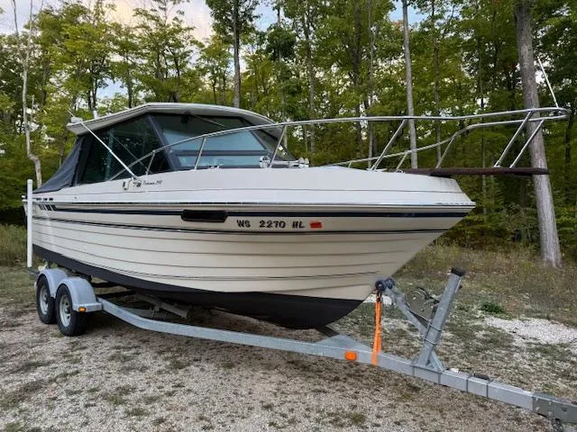 Slide: The Image of 1990 Thompson 240 Fisherman boat on trailer, parked in wooded area. - 3