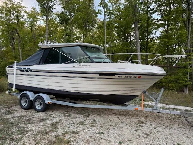 Slide: The Image of 1990 Thompson 240 Fisherman boat on trailer, parked in wooded area. - 4