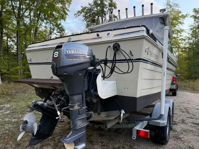 Slide: The Image of 1990 Thompson 240 Fisherman boat with Yamaha motor on trailer in wooded area. - 6