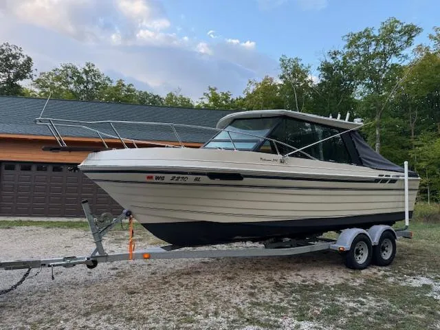 Slide: The Image of 1990 Thompson 240 Fisherman boat on trailer, parked outdoors near a garage. - 8