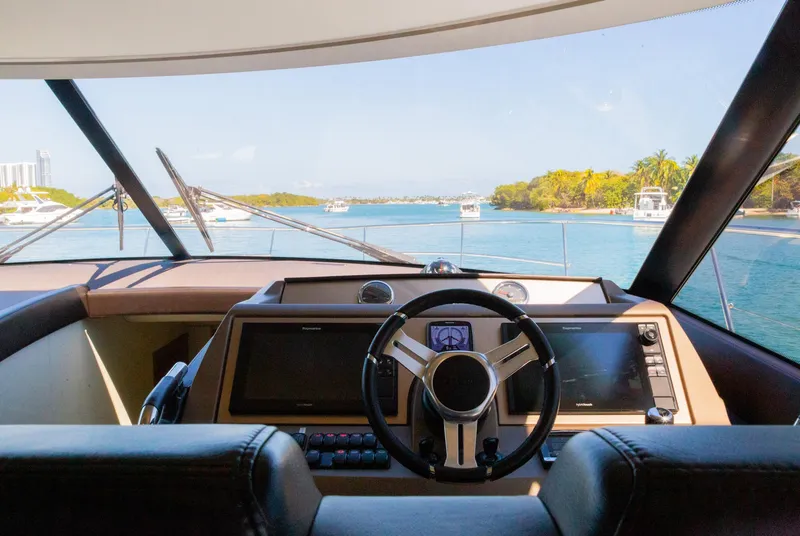 Slide: The Image of Prestige 560 Flybridge 2018 yacht helm with scenic waterway view. - 23