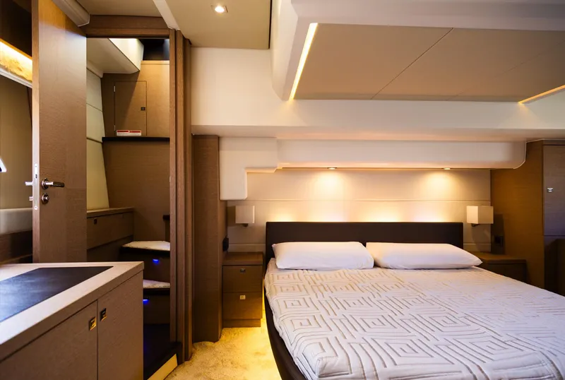 Slide: The Image of Luxurious bedroom interior of 2018 Prestige 560 Flybridge yacht, featuring modern design and ambient lighting. - 25