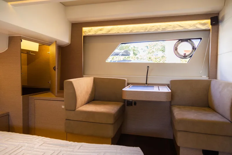 Slide: The Image of Luxurious interior of 2018 Prestige 560 Flybridge yacht with elegant seating and window view. - 33