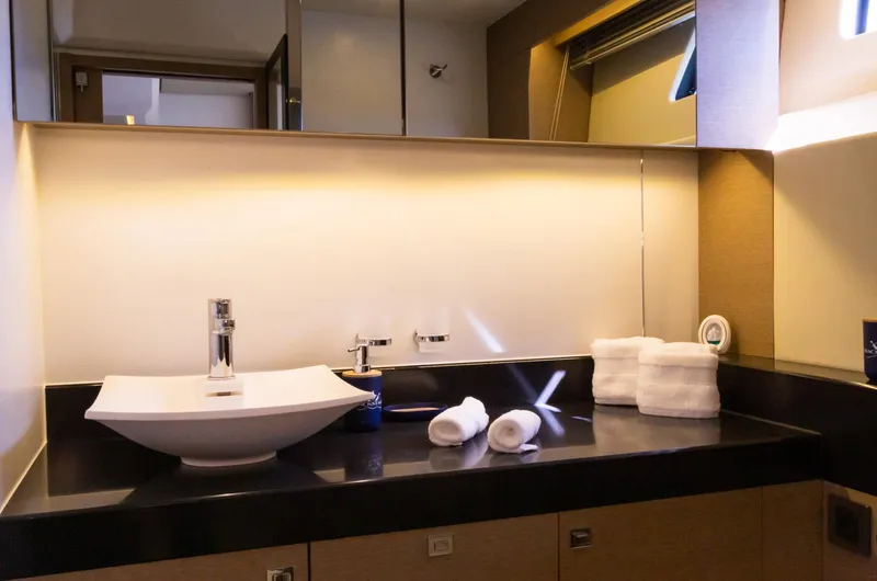 Slide: The Image of Luxurious bathroom in 2018 Prestige 560 Flybridge yacht with modern sink and elegant lighting. - 34