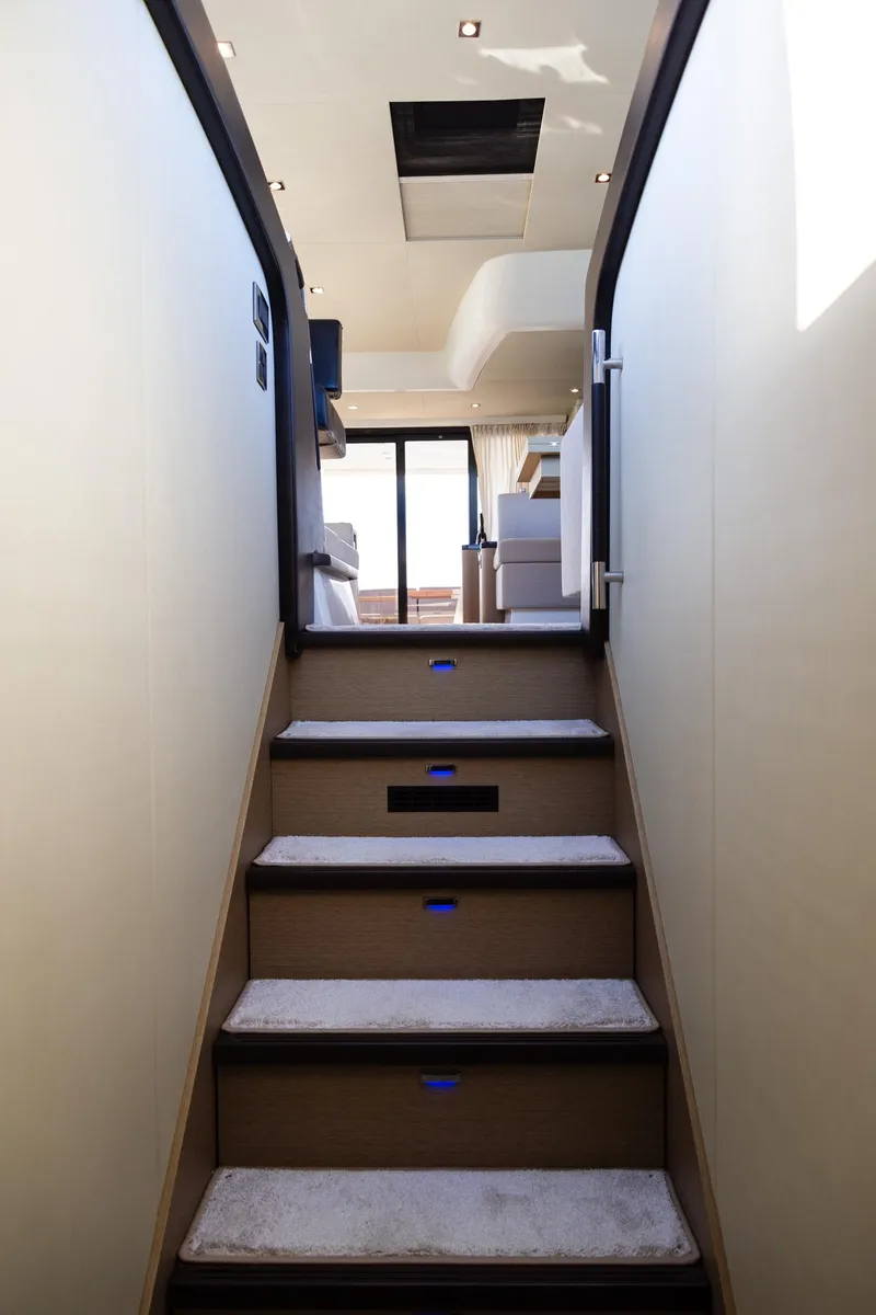 Slide: The Image of Staircase inside 2018 Prestige 560 Flybridge yacht, leading to upper deck with modern interior. - 35