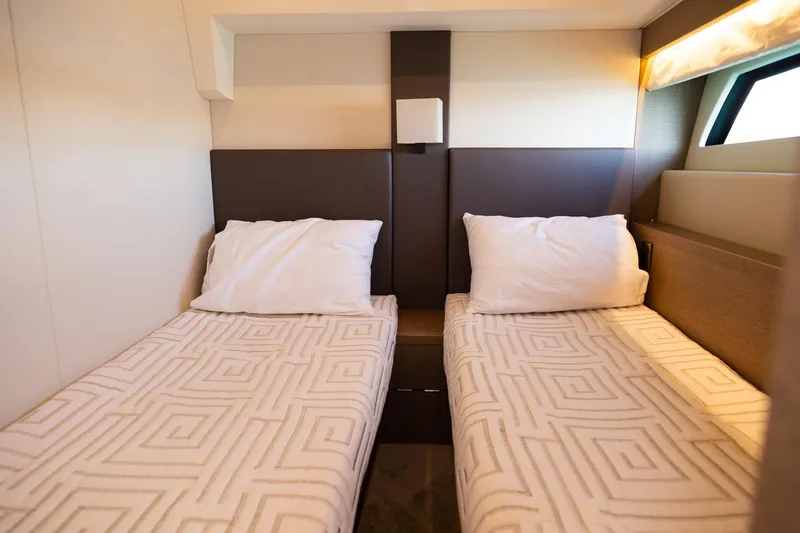 Slide: The Image of Twin beds in 2018 Prestige 560 Flybridge yacht cabin, modern design and cozy ambiance. - 37