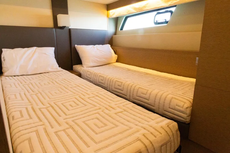 Slide: The Image of Twin beds in a 2018 Prestige 560 Flybridge yacht cabin, featuring modern decor. - 38