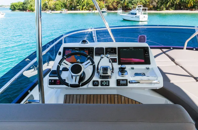 Slide: The Image of Flybridge helm of 2018 Prestige 560 yacht with scenic ocean view. - 8