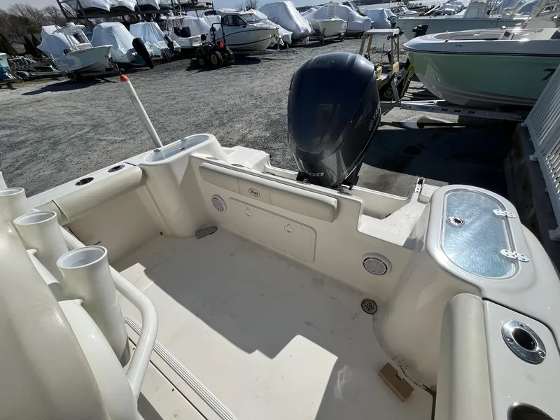 Slide: The Image of 2019 Key West 244 Center Console boat with outboard motor in a marina. - 10