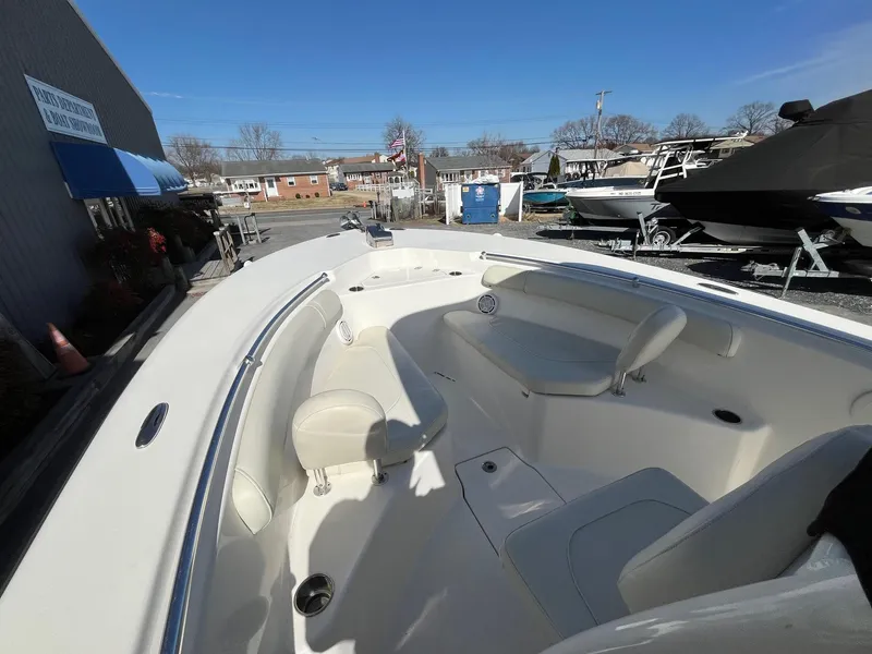 Slide: The Image of 2019 Key West 244 Center Console boat with spacious seating, docked outdoors. - 18