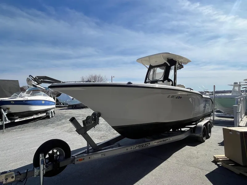 Slide: The Image of 2019 Key West 244 Center Console boat on trailer under clear sky. - 2