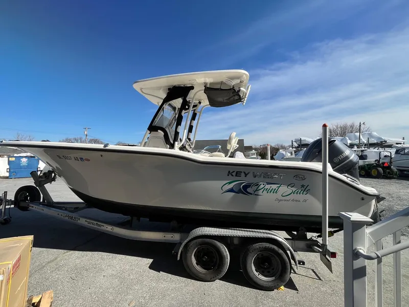 Slide: The Image of 2019 Key West 244 Center Console boat on trailer under clear blue sky. - 3