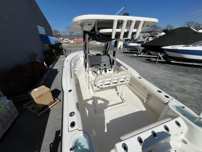 Slide: The Image of 2019 Key West 244 Center Console boat, white interior, docked outdoors under clear sky. - 6