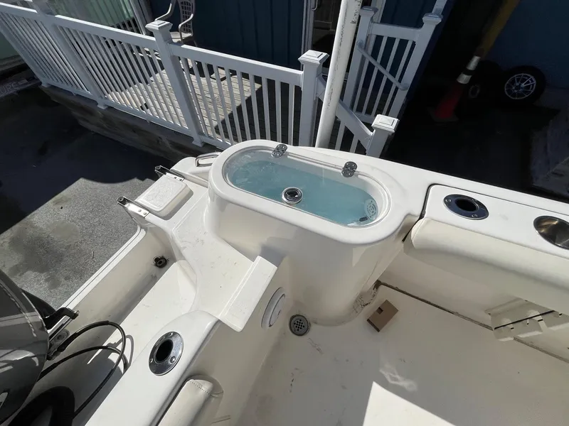 Slide: The Image of 2019 Key West 244 Center Console boat with livewell and rod holders. - 8