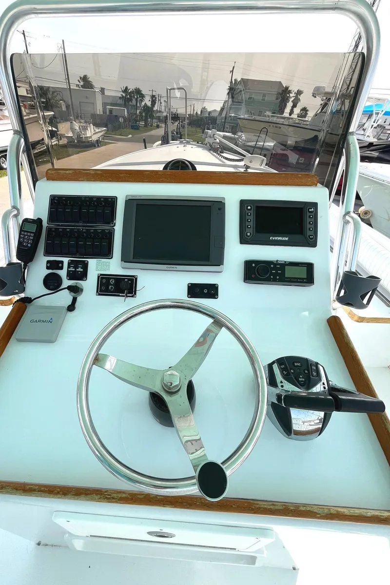 Slide: The Image of 1966 Bertram 31 boat helm with steering wheel and navigation instruments. - 10