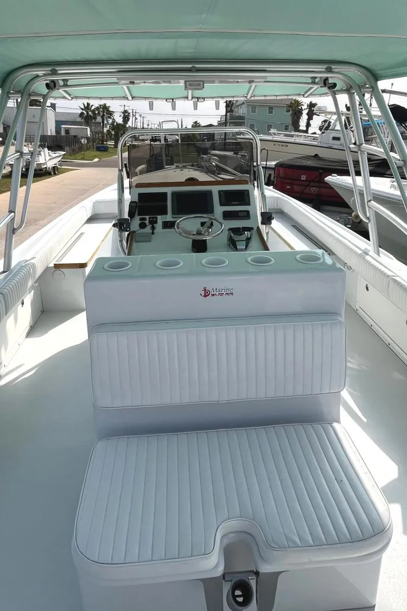 Slide: The Image of 1966 Bertram 31 boat interior with white seating and control panel. - 11