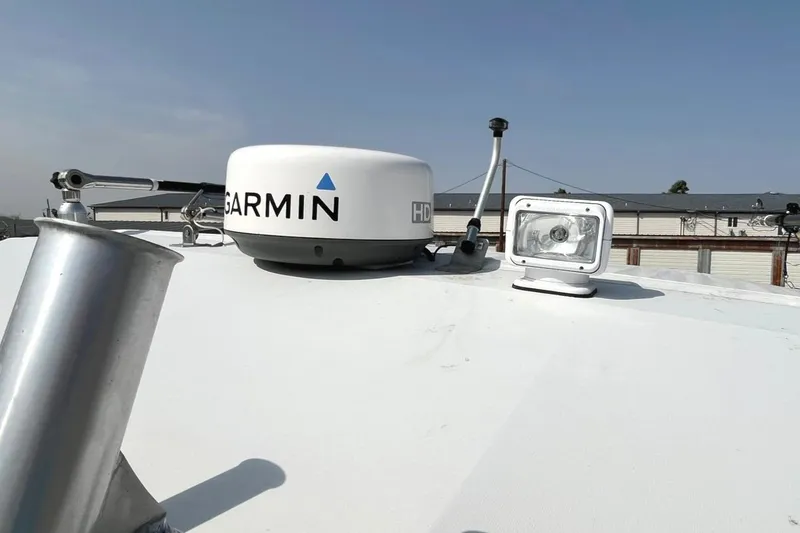 Slide: The Image of 1966 Bertram 31 boat with Garmin radar and spotlight on deck. - 12