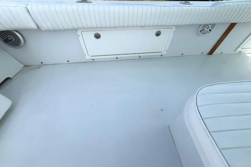 Slide: The Image of 1966 Bertram 31 boat interior with white seating and storage compartment. - 14