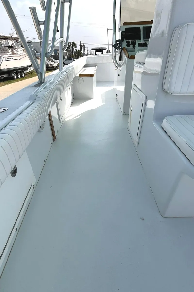 Slide: The Image of 1966 Bertram 31 boat interior with white seating and steering console. - 15