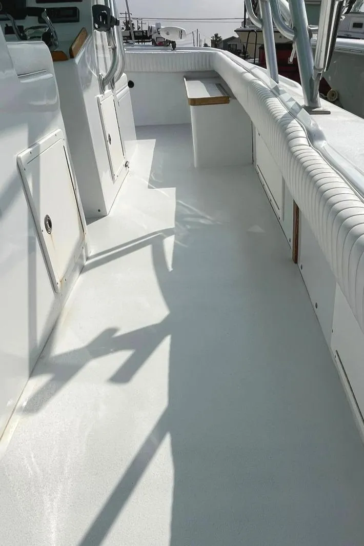 Slide: The Image of 1966 Bertram 31 boat deck with white finish and seating area. - 18