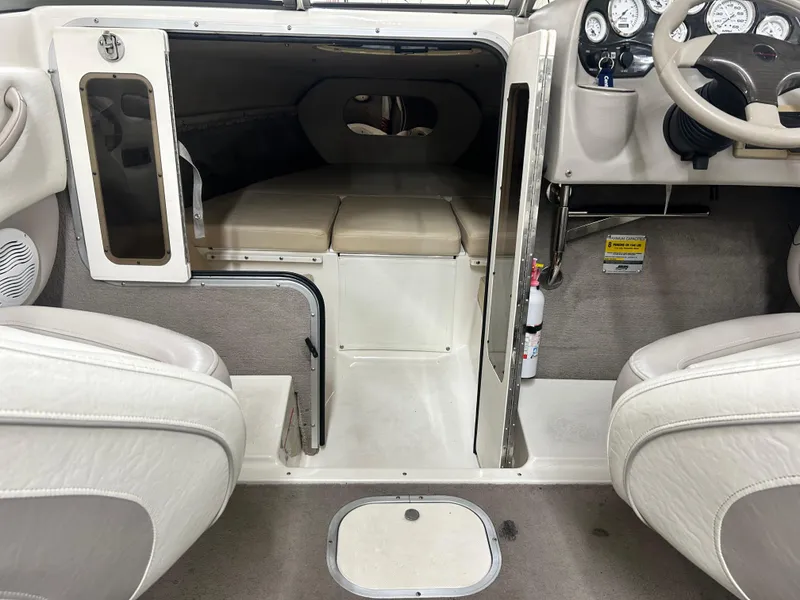Slide: The Image of Interior of 2006 Stingray 205 Cuddy M/C boat, featuring cabin and dashboard. - 11