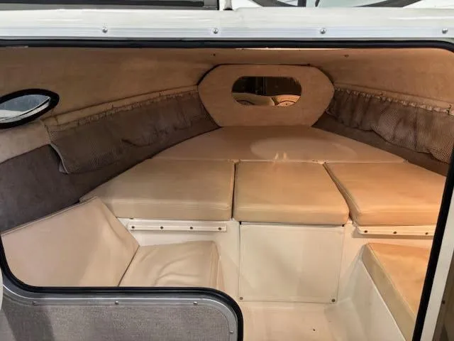 Slide: The Image of 2006 Stingray 200 CX Cuddy cabin interior with cushioned seating and storage. - 12