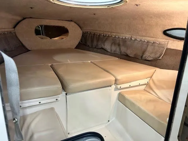 Slide: The Image of 2006 Stingray 200 CX Cuddy cabin interior with beige cushions and storage compartments. - 13