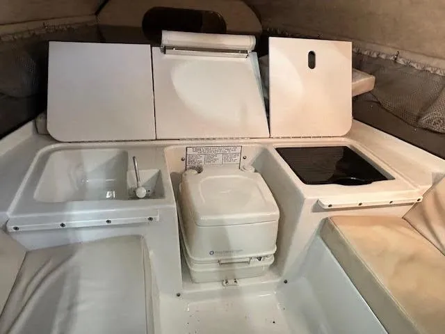 Slide: The Image of 2006 Stingray 200 CX Cuddy cabin interior with sink, stove, and seating area. - 14