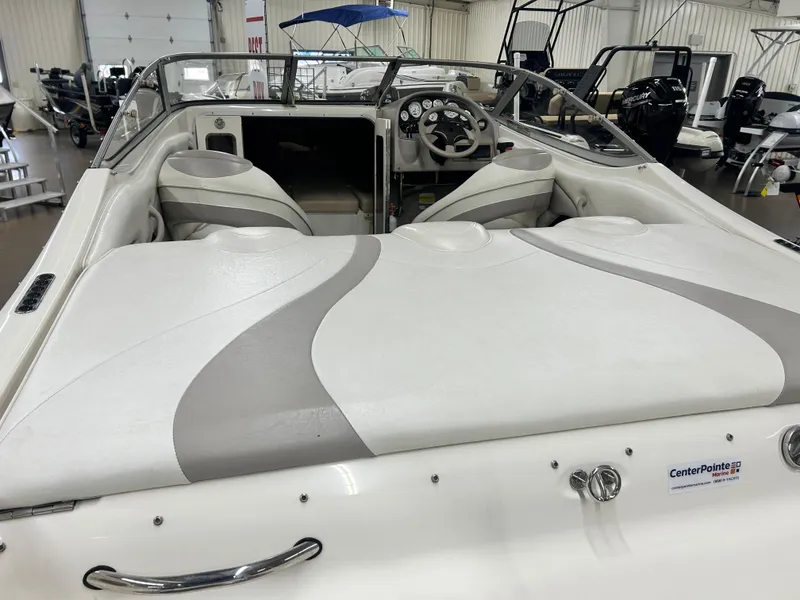 Slide: The Image of 2006 Stingray 205 Cuddy M/C boat interior with steering wheel and seating. - 4