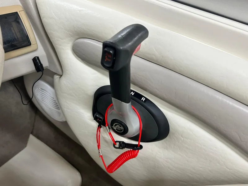 Slide: The Image of 2006 Stingray 205 Cuddy M/C throttle control with safety lanyard in boat interior. - 9